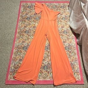 Peach colored one shoulder jumpsuit by Shelli Segal